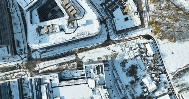Snow-covered city buildings and roads