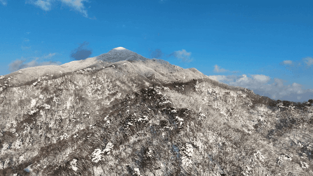 Snow-covered mountain under a clear blue sky