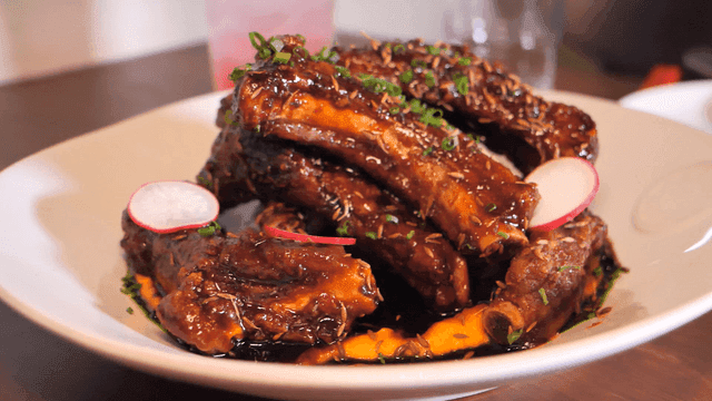 Delicious glazed marinated ribs on plate