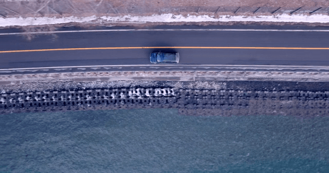 Car driving along a coastal road