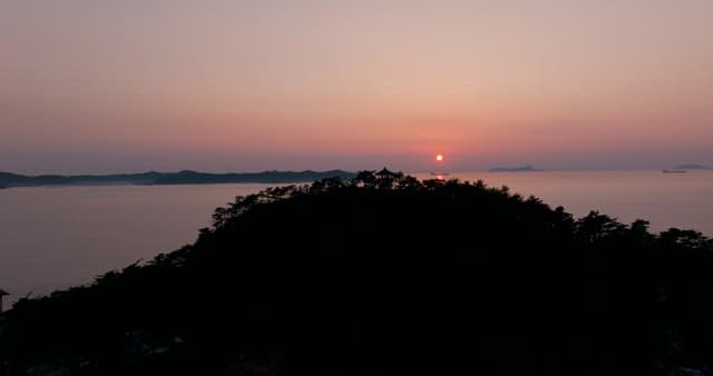 Serene Sunset Over Coastal Hills and the Ocean