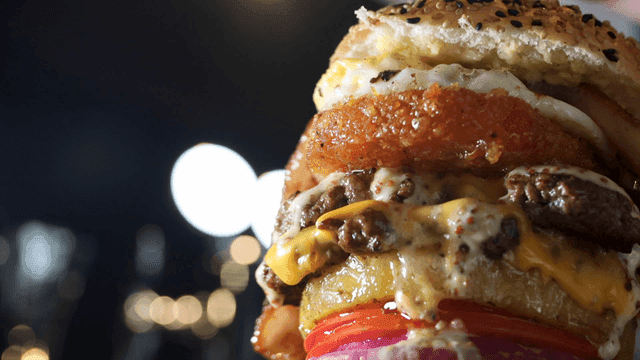 Burger stacked high with layered ingredients