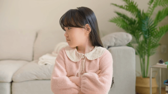 Sulky child with her arms crossed