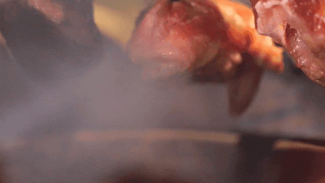 Skewers grilling in rising smoke