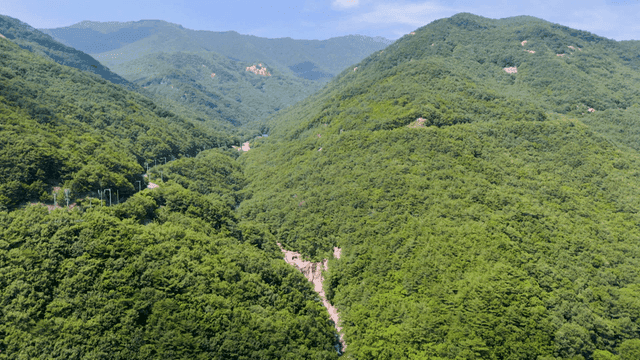 맑은 하늘 아래 푸르고 높은 산