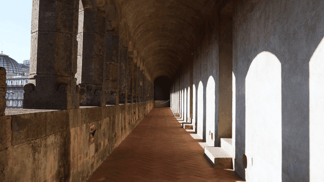 Historic corridor with arched shadows