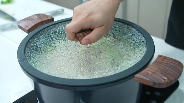 Appetizing Kalguksu boiling in a pot on the stove