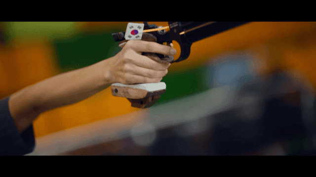 Person holding a pistol in a shooting range