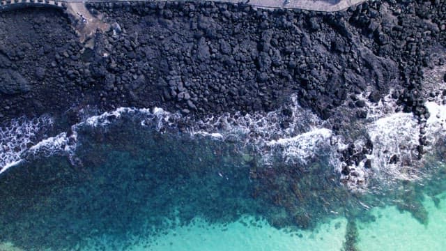 Rocky Shoreline with Waves and Trail