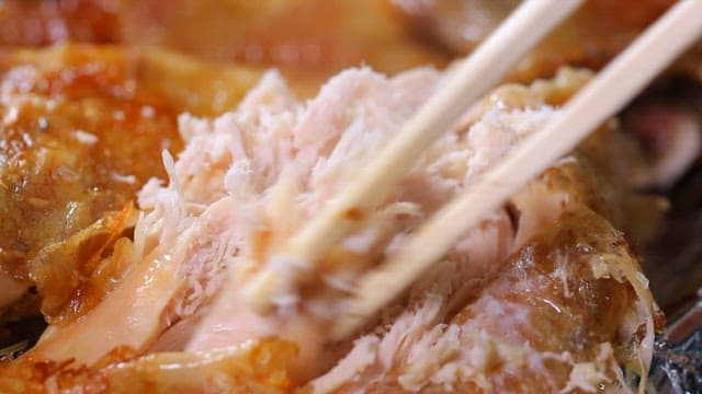 Chopsticks picking roasted chicken