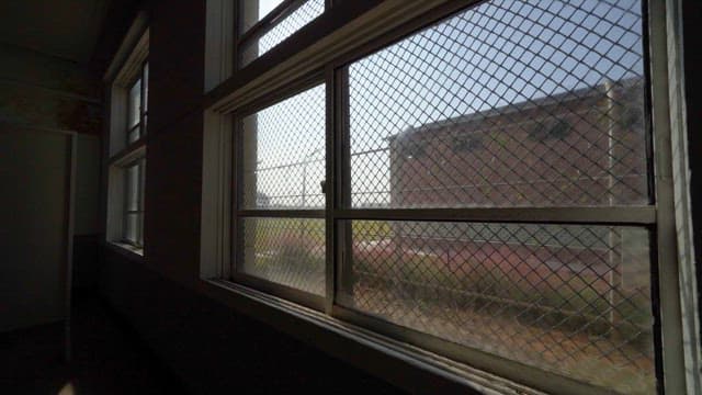 Sunlight Through a Window Surrounded by Barbed Wire