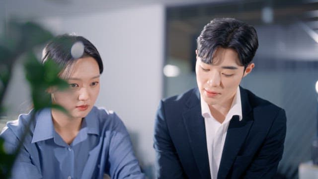 Two colleagues discussing documents