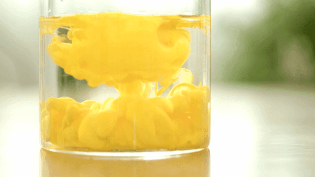 Yellow liquid swirling in a glass