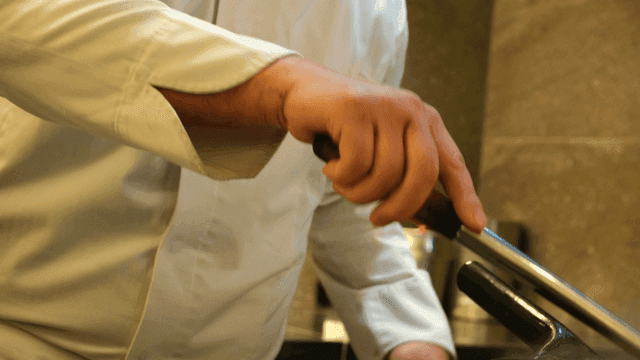 Chef stirring with ladle