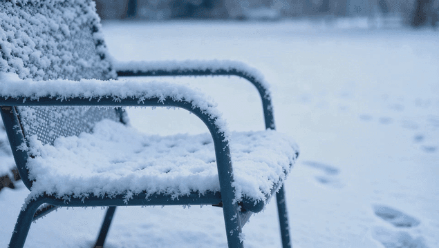 Chair covered in snow in a winter landscape