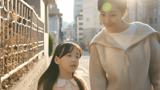Child walking home from school with her mother