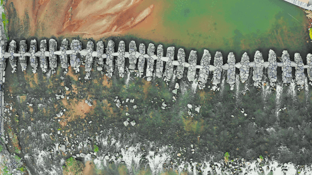 Aerial view of a stone bridge crossing a river