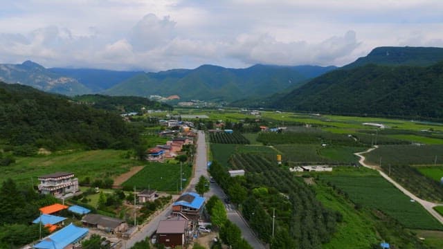 Expansive green fields with distant mountains