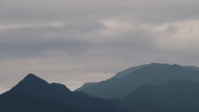 Clouds moving over a mountain