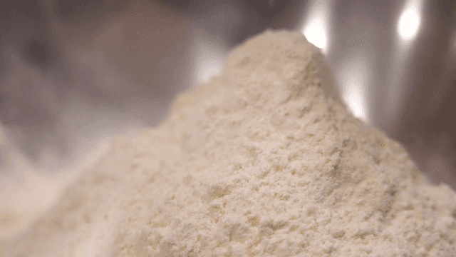 Flour being poured into a mixing bowl