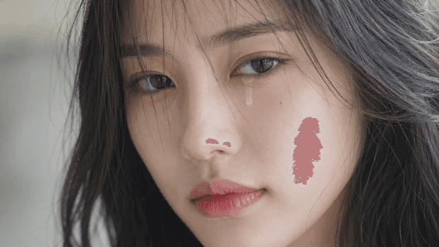 Young woman looking straight ahead and shedding tears