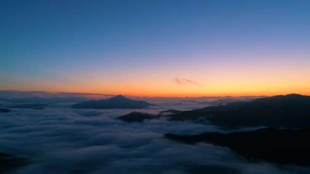 Misty mountains at dawn with vibrant skies