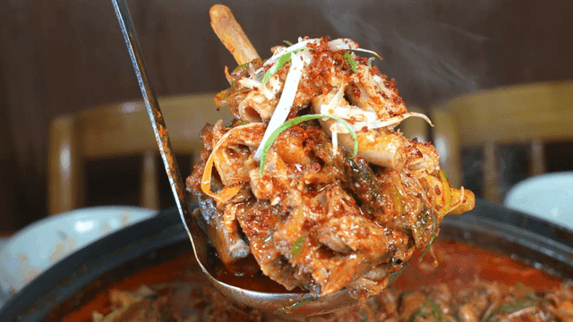 Tripe and pork backbone stew scooped out with ladle