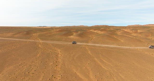 Vehicle traveling through a vast desert