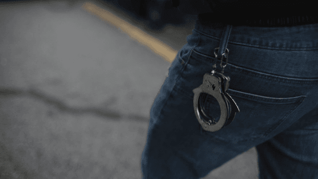 Handcuffs hanging from jeans pocket