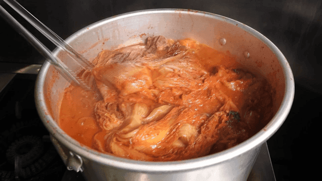 Kimchi stew boiling in large pot