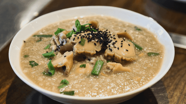 Abalone porridge garnished with sesame seeds