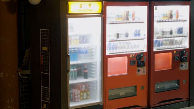 Person Selecting Drinks at a Vending Machine