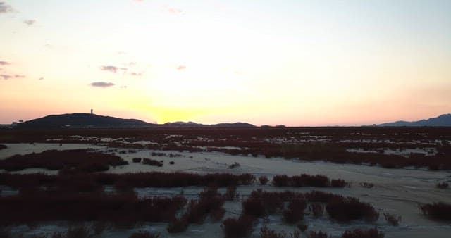 Sunset over a vast landscape with hills