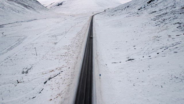 Car driving on a snowy mountain road