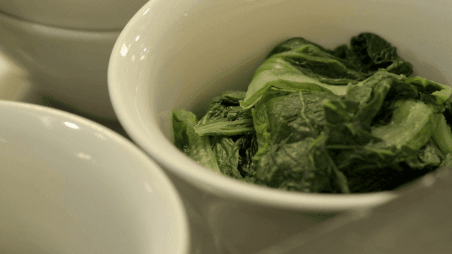 Fresh green vegetables in a white bowl