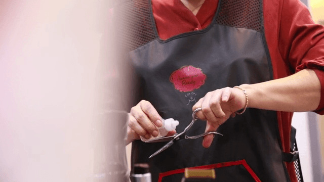 Hairdresser cleaning hair scissors