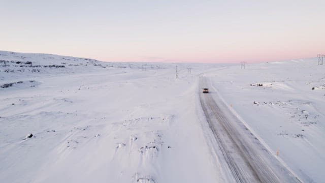 Car driving on a snowy mountain road