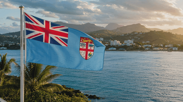 Fijian flag fluttering on beach