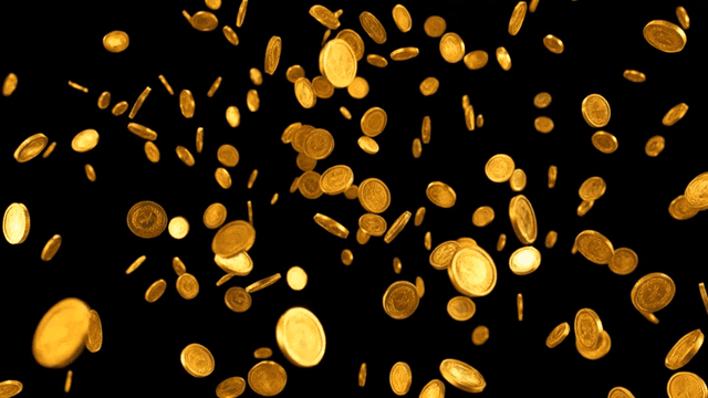 Gold coins falling against a black background
