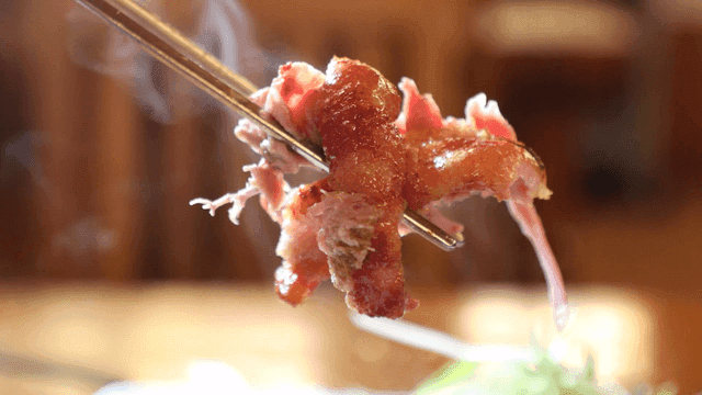 Smoked duck meat eaten with chopsticks