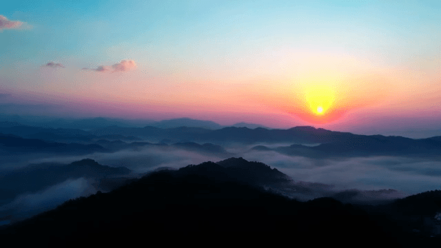 Sunrise over a cloudy mountain landscape