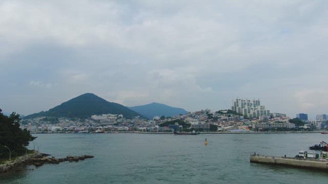 Coastal city with mountains in the background