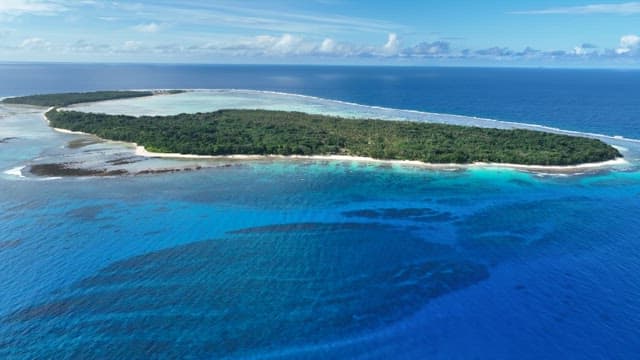 Aerial view of a tropical island with clear blue waters