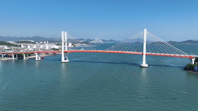 Bridge over a calm sea with cable cars