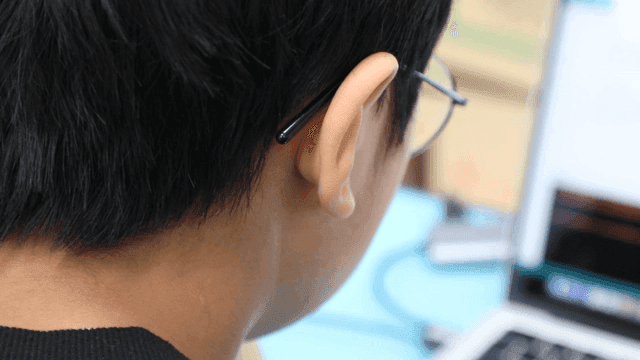 Elementary school students focused on their laptop screens