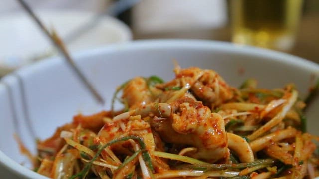 Spicy sea snails salad with green onions and dried monkfish