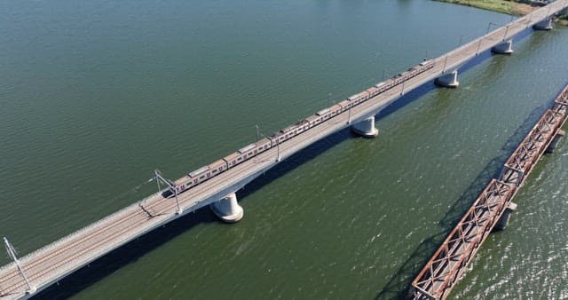 Train crossing a bridge over a river