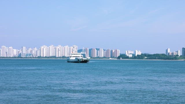 Ferry sailing near a city skyline