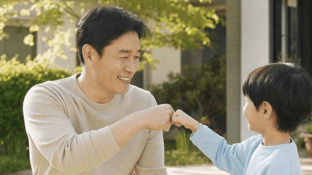 Grandfather and child exchanging fist bumps