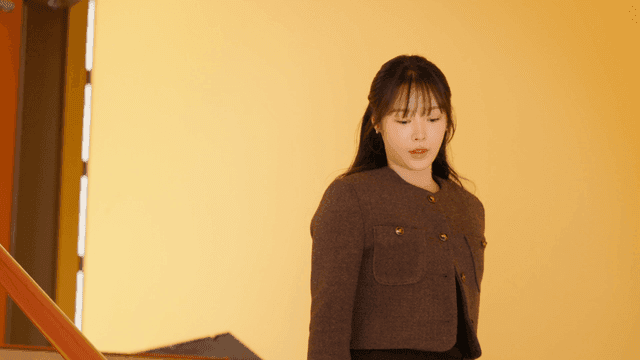 Young woman walking down indoor staircase